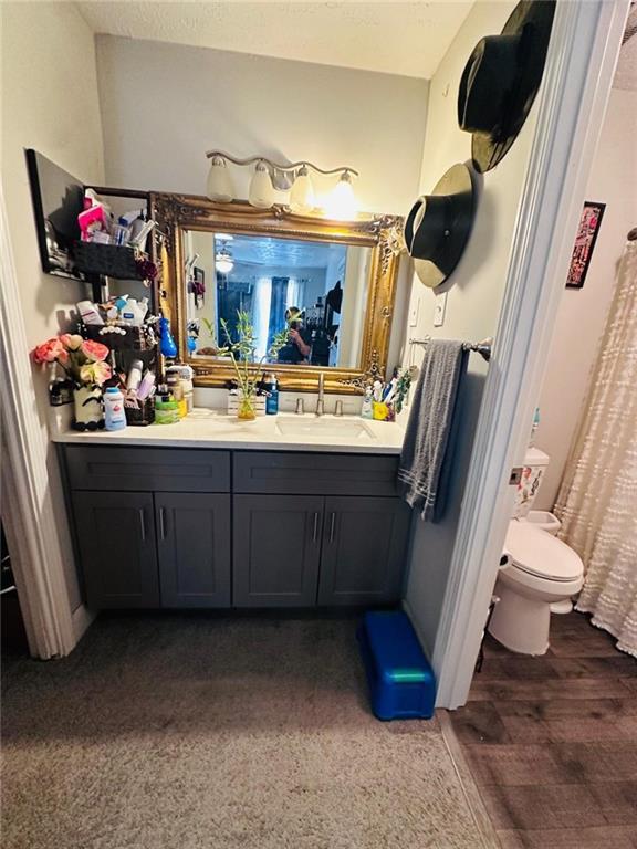 4312 Idlewood Ln, Tucker, GA 30084 - full bath with toilet, vanity, and wood finished floors
