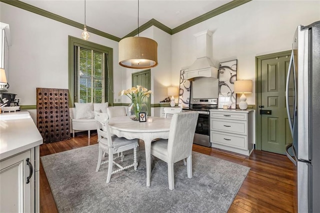 dining space featuring crown molding and dark wood-type flooring