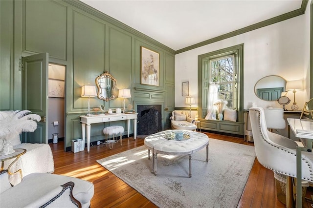 kitchen with pendant lighting, dark wood-type flooring, ornamental molding, appliances with stainless steel finishes, and white cabinetry