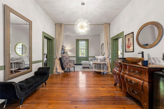 stairway featuring a chandelier, wood-type flooring, and vaulted ceiling