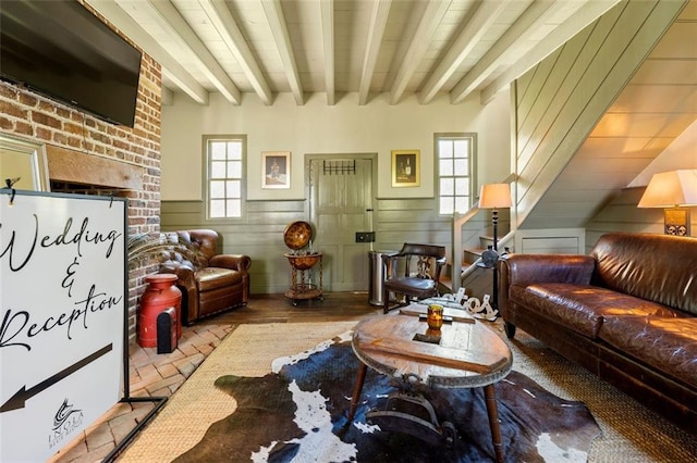 living room with a healthy amount of sunlight, light wood-type flooring, and beam ceiling