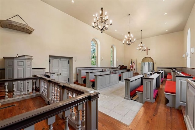 kitchen with decorative light fixtures, a center island, and light hardwood / wood-style floors