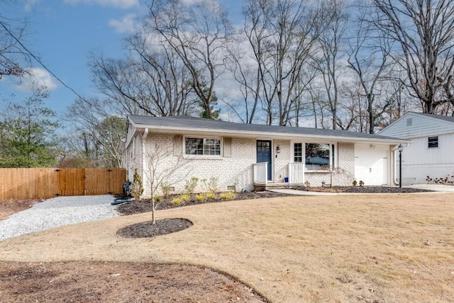 ranch-style house with a front yard and a garage