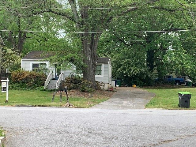 obstructed view of property with a front lawn