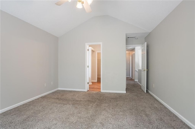 unfurnished bedroom with carpet floors, lofted ceiling, baseboards, and a ceiling fan