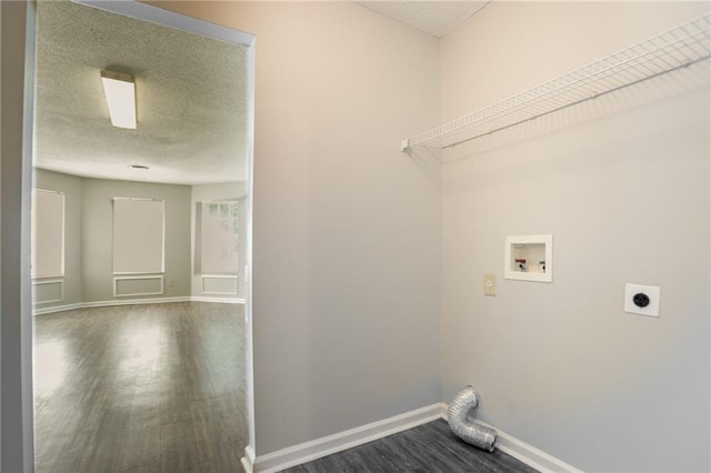 washroom featuring electric dryer hookup, dark wood finished floors, hookup for a washing machine, a textured ceiling, and baseboards