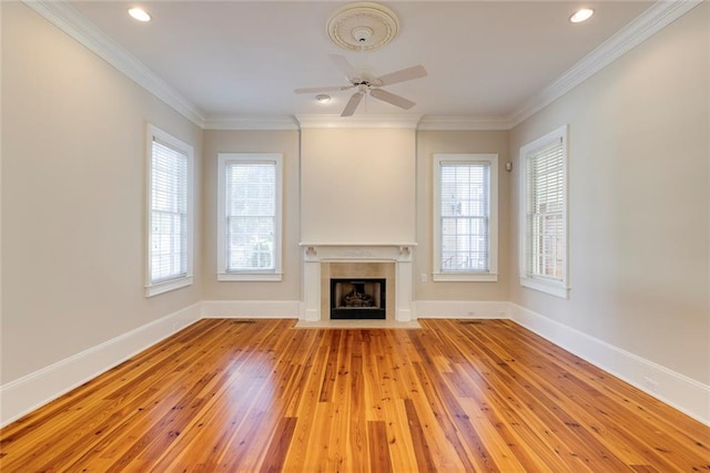 unfurnished living room featuring ornamental molding, ceiling fan, and light hardwood / wood-style flooring