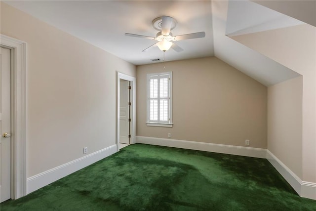 additional living space featuring ceiling fan, dark colored carpet, and vaulted ceiling