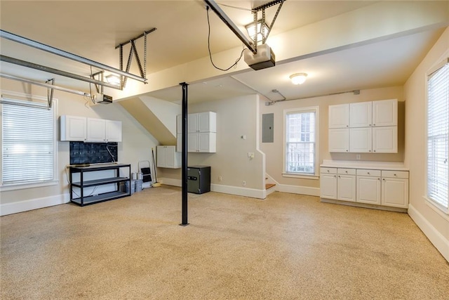 garage with electric panel and a garage door opener