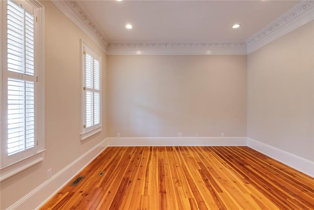 unfurnished room with wood-type flooring and ornamental molding