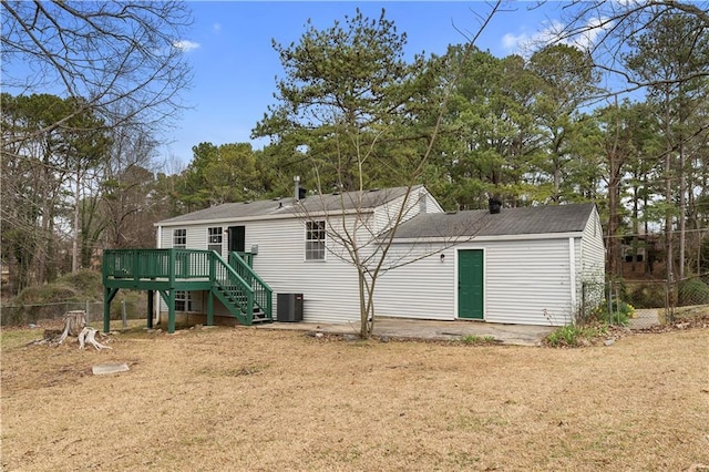 back of property with stairway, central AC unit, and a deck