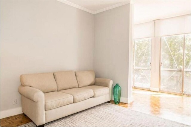 living room with parquet flooring and ornamental molding