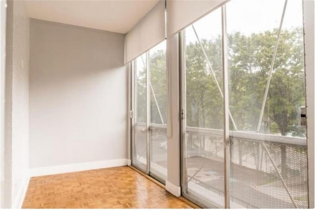 doorway to outside with light parquet floors