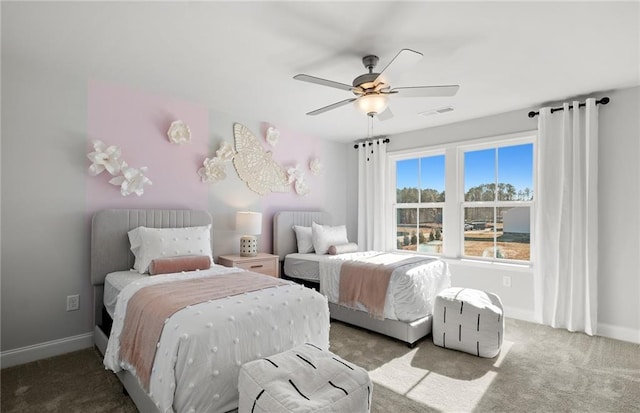 carpeted bedroom with visible vents, baseboards, and ceiling fan