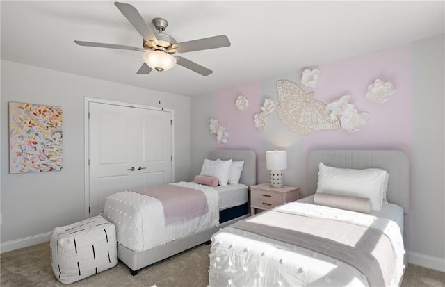 bedroom with a closet, carpet flooring, baseboards, and a ceiling fan