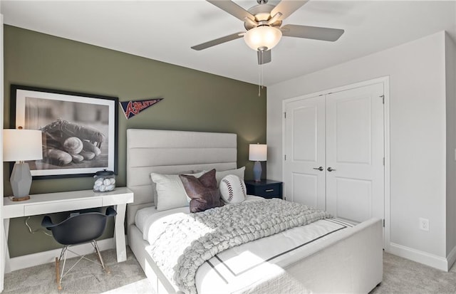 bedroom featuring a closet, baseboards, a ceiling fan, and carpet floors
