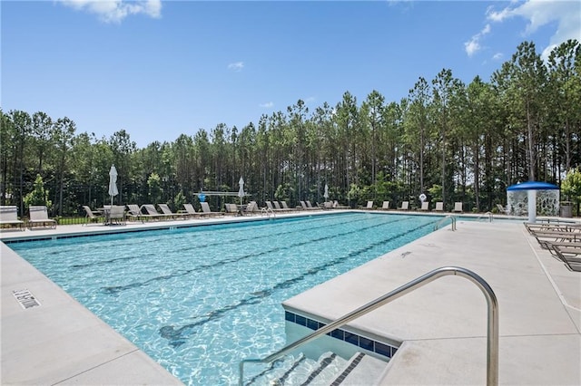 community pool featuring a patio area and fence