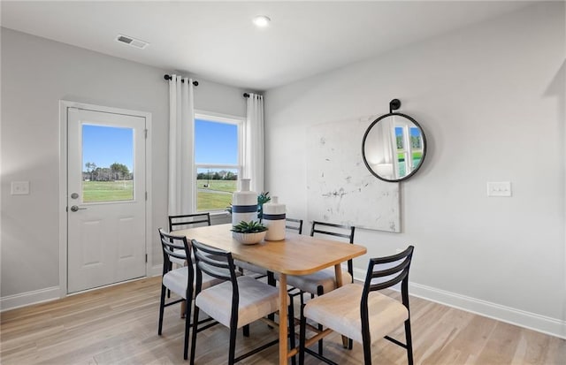 dining space featuring visible vents, baseboards, and light wood-type flooring