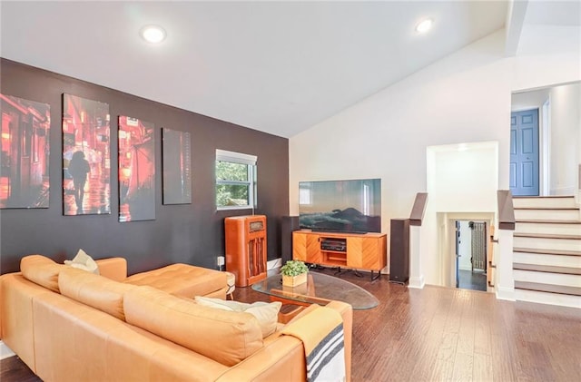 living room with dark hardwood / wood-style floors and high vaulted ceiling