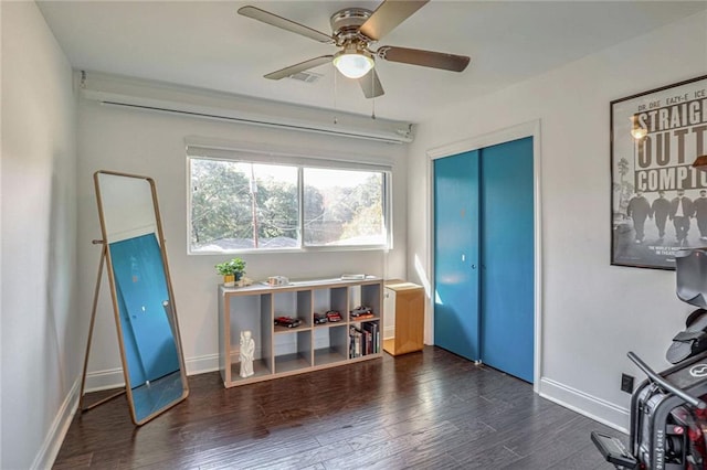 interior space featuring dark wood-type flooring and ceiling fan