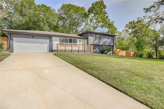 split level home with a front lawn and a garage