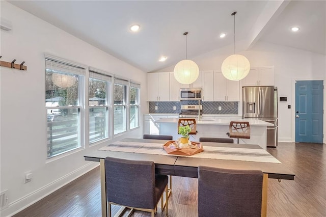 dining area with lofted ceiling with beams and dark hardwood / wood-style flooring