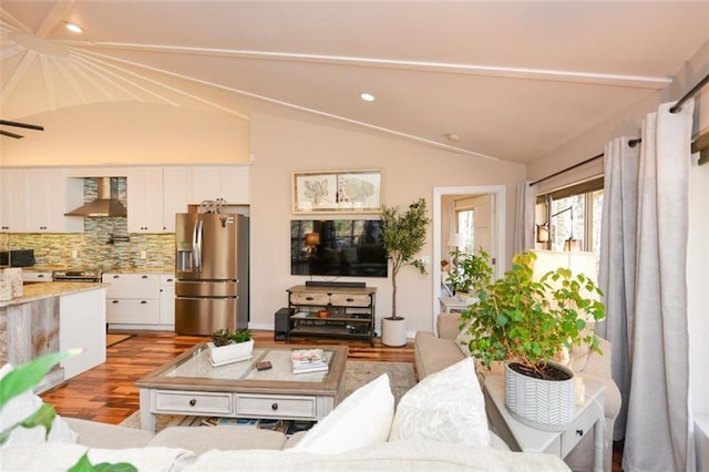 living area with light wood-style flooring, vaulted ceiling, and recessed lighting