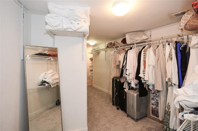 walk in closet with light carpet and visible vents