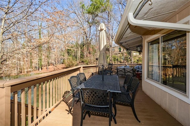 wooden terrace featuring outdoor dining area