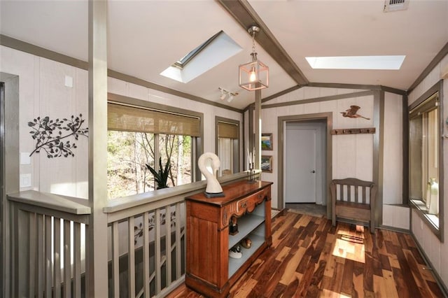 hallway with dark wood-style flooring, lofted ceiling with skylight, and visible vents