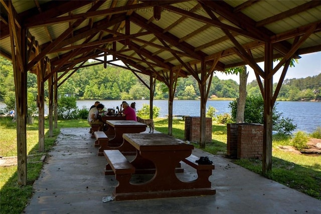 surrounding community with a patio area, a water view, a view of trees, and a gazebo