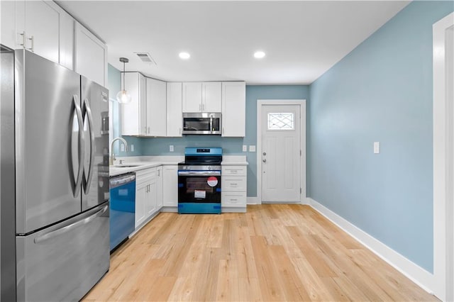 5233 Groovers Landing Rd SE, Acworth, GA 30101 - kitchen with appliances with stainless steel finishes, white cabinetry, light wood-type flooring, light countertops, and recessed lighting