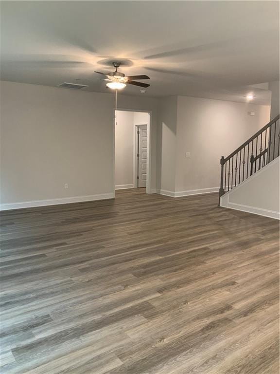 empty room featuring ceiling fan and dark wood-type flooring