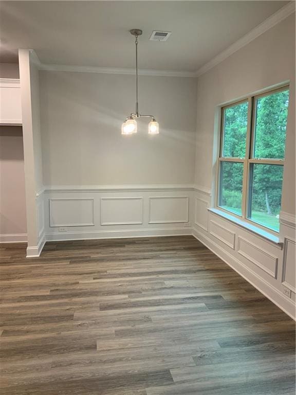 unfurnished dining area with crown molding and dark hardwood / wood-style flooring