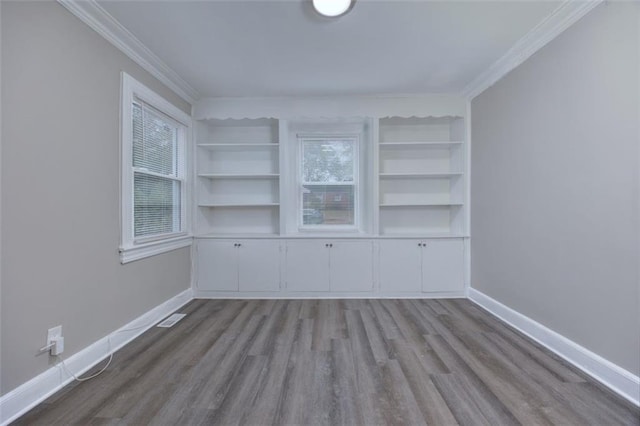 spare room with ornamental molding and light hardwood / wood-style flooring