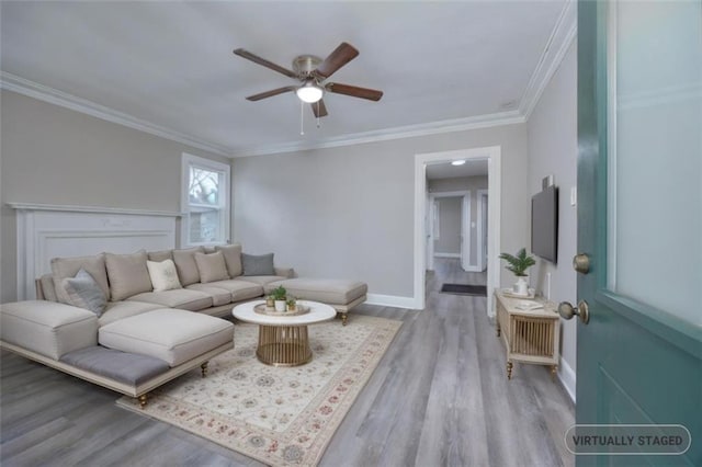 living room with light hardwood / wood-style floors, ceiling fan, and ornamental molding