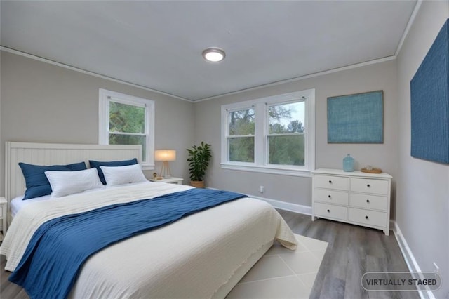 bedroom with hardwood / wood-style flooring and crown molding