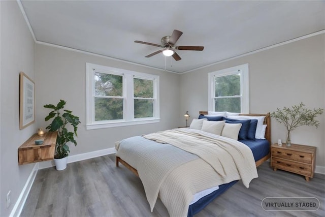 bedroom with multiple windows, ceiling fan, and crown molding