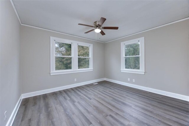 unfurnished room with a healthy amount of sunlight, light wood-type flooring, and crown molding