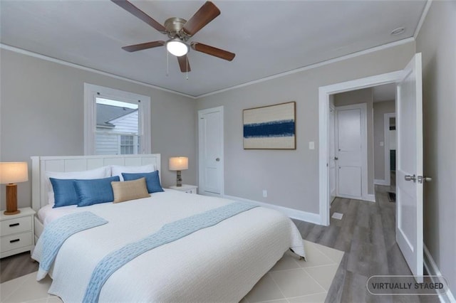 bedroom with hardwood / wood-style floors, ceiling fan, and ornamental molding