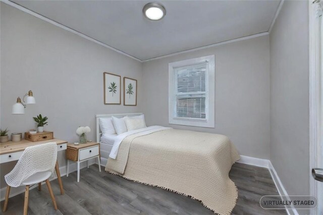 bedroom featuring dark hardwood / wood-style floors and crown molding