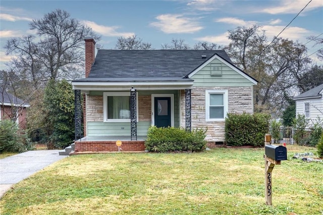 bungalow-style house with a front yard