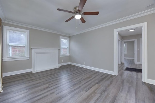 empty room featuring ceiling fan, hardwood / wood-style floors, and ornamental molding