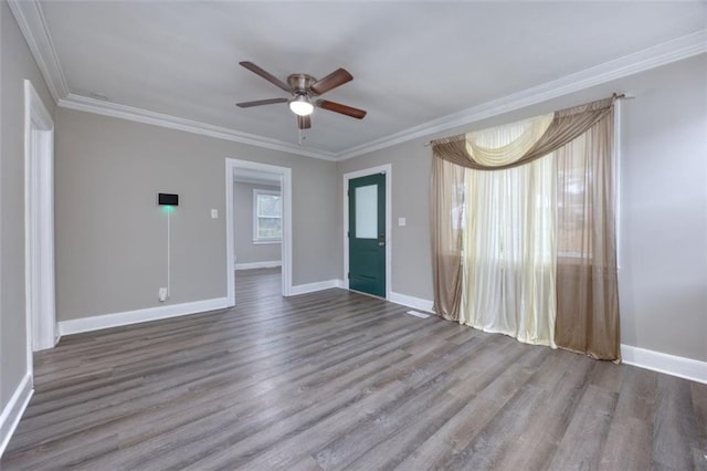 unfurnished room featuring ceiling fan, wood-type flooring, and crown molding