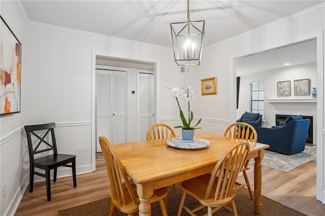 1771 Defoor Ave NW Unit D, Atlanta, GA 30318 - dining room featuring wood finished floors, ornamental molding, a chandelier, and a fireplace