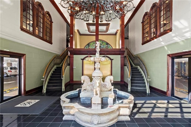 3334 Peachtree Rd NE Unit 1609, Atlanta, GA 30326 - tiled foyer entrance with a chandelier, ornamental molding, stairs, and a towering ceiling