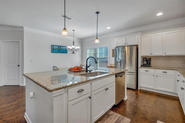 kitchen featuring white cabinetry, sink, appliances with stainless steel finishes, and a center island with sink