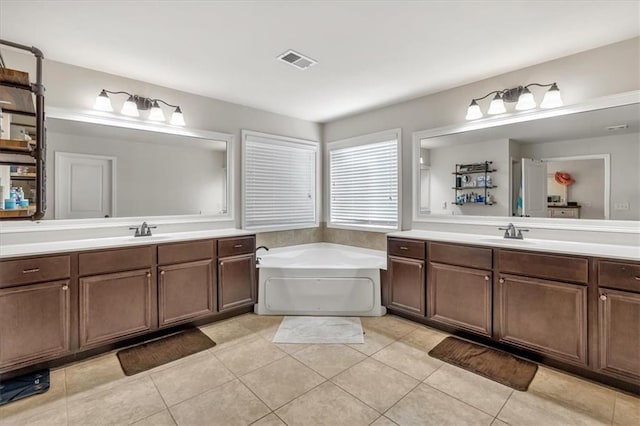 bathroom with vanity, tile patterned flooring, and a tub