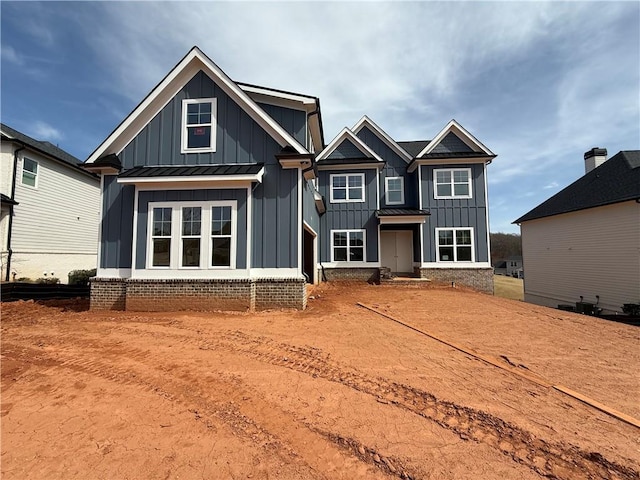 view of front of house with a standing seam roof, metal roof, and board and batten siding