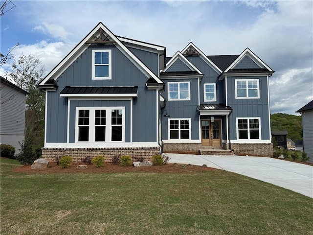 craftsman house with a standing seam roof, board and batten siding, a front yard, and metal roof